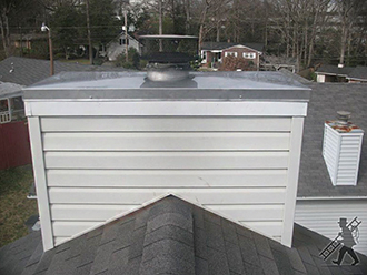 white chimney with metal top on rooftop